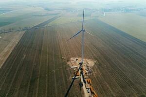 Construction site near windmill turbine, Wind generator installing photo