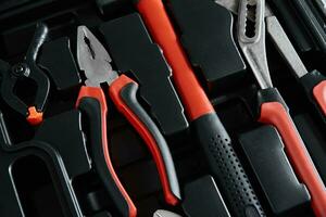 Set of tools for repair and maintenance on black background photo