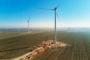 Construction site near windmill turbine, Wind generator installing photo