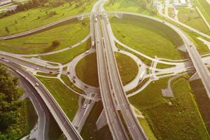 Cars moving on transport road junction in city, aerial view photo