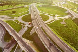 Cars moving on transport road junction in city, aerial view photo