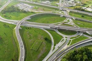 Cars moving on transport road junction in city, aerial view photo