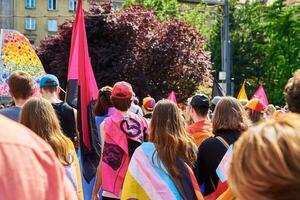 People crowd with LGBTQ rainbow flags on pride demonstration photo