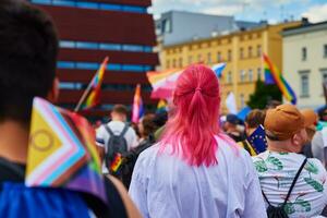 People crowd with LGBTQ rainbow flags on pride demonstration photo