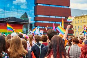 People crowd with LGBTQ rainbow flags on pride demonstration photo