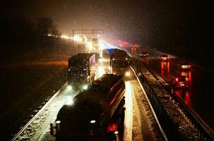 Car accident on slippery road at night during snowfall photo