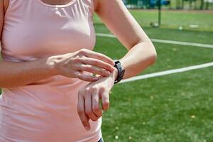 Woman use fitness smart watch, checking results after sport training photo