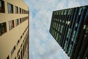 Two buildings facade against sky photo