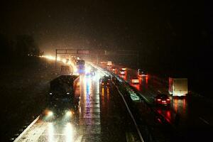 Car accident on slippery road at night during snowfall photo