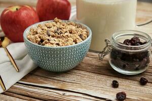 Morning breakfast with granola on wooden background photo