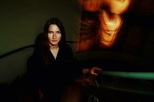 Creative woman portrait with dark blurred background photo