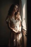 natural portrait of a European young girl in simple rustic clothes standing by the window, natural photo, soft light, art photo