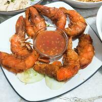 fried shrimps with sauce and lemon photo