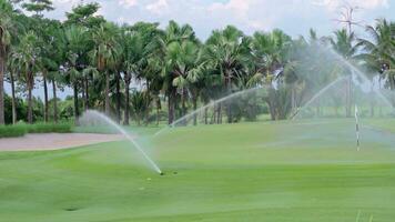 Automatic high-pressure water sprinkler at green golf course watering the grass video