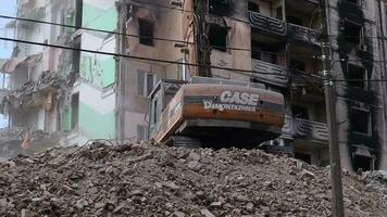 The destruction of a multi-storey building after being hit by an artillery shell. A burnt-out high-rise building in a war zone. War in residential areas, broken windows. Ukraine, Irpin - May 12, 2023. video