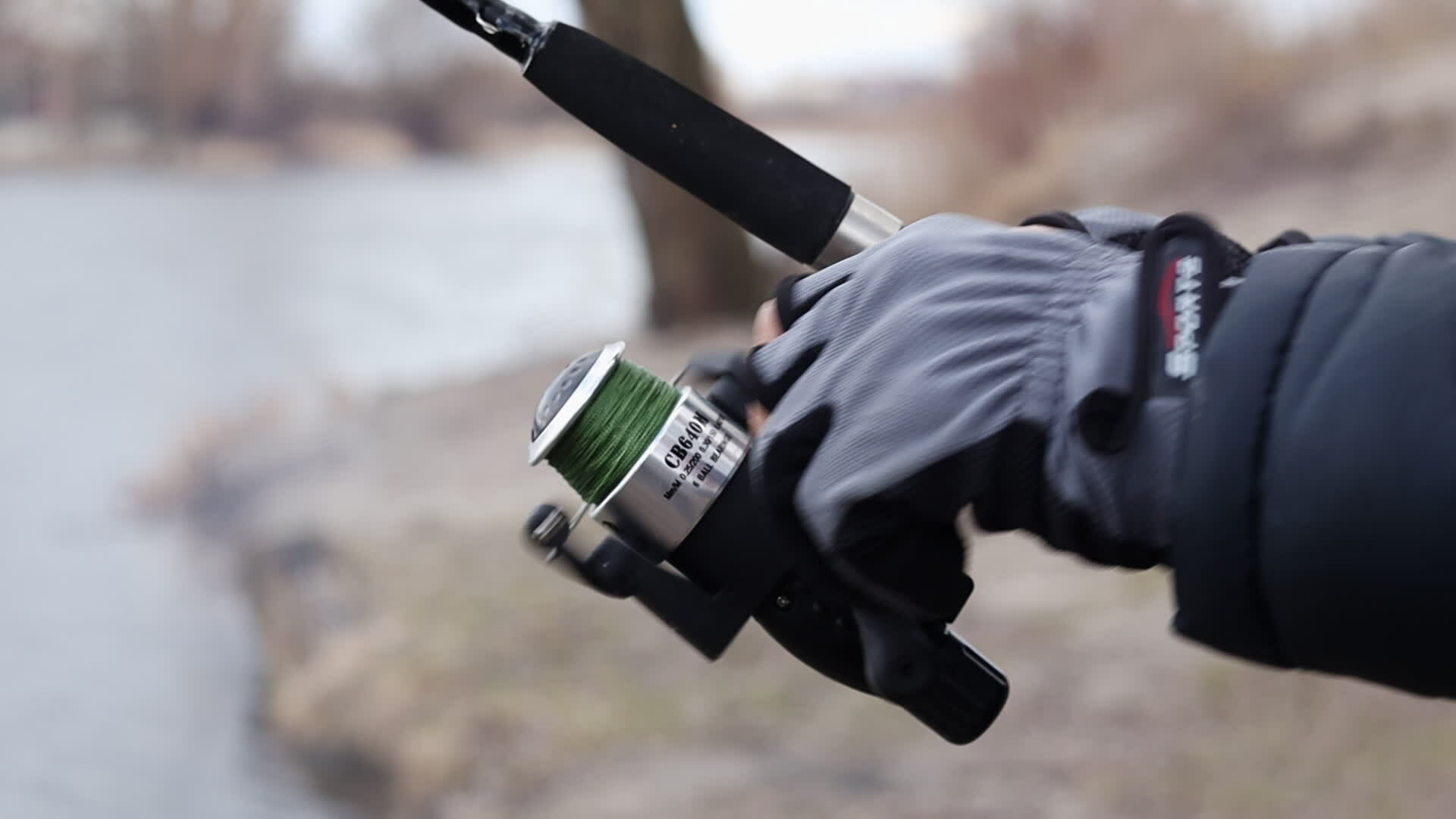 Close up of a fisherman's hands with a spinning reel. Spin fishing