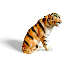 Sitting tiger animal miniature isolated on white photo