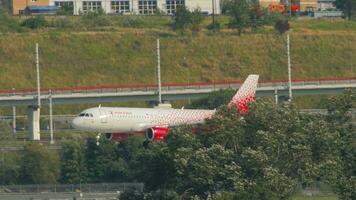 SOCHI, RUSSIA AUGUST 02, 2022 - Side view Airbus A320, RA 73207 of Rossiya landing at Sochi airport. Airplane flies low over the city. Tourism and travel concept video