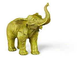 The elephant statue is gold in color on a white background photo