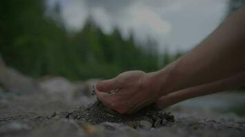 Sand Stones Falling Into Hands of Person in Slow Motion video