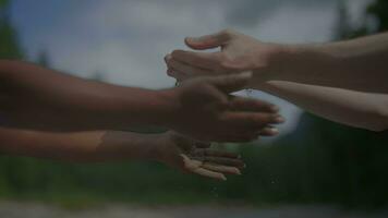 Teamwork of a Man and a Woman Dropping Sand Into Each Others Hands Outdoors in Nature video