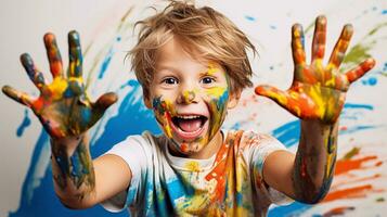 Cute little boy laughing together and having fun with paints. Painted in skin hands. Child portrait. Creative concept. Close up photo