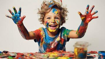 Cute little boy laughing together and having fun with paints. Painted in skin hands. Child portrait. Creative concept. Close up photo