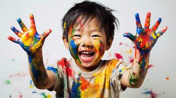 Cute little boy laughing together and having fun with paints. Painted in skin hands. Child portrait. Creative concept. Close up photo