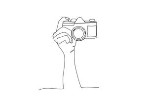A hand photographing the object from above vector