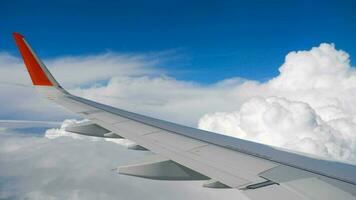 Wing of airplane on sky and cloud on moving, view from airplane cabine video