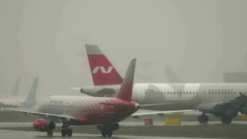 MOSCOW, RUSSIAN FEDERATION JULY 28, 2021 - Foggy rainy morning at the airport. Airbus A321 211, VQ BOE of Nordwind Airlines taxiing to the runway, taking off in rainy weather. video