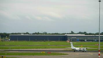 AMSTERDAM, THE NETHERLANDS JULY 29, 2017 - Garuda Indonesia Boeing 777 PK GIA take off and FlyBe Bombardier Dash 8 G ECOF taxiing, Shiphol Airport, Amsterdam, Holland video