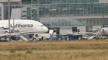 FRANKFURT AM MAIN, GERMANY JULY 17, 2017 - Widebody passenger airliner Lufthansa taxiing at Frankfurt airport, side view. Tourism and travel concept. Aircraft on apron video