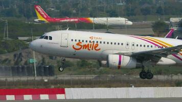 BANGKOK, THAILAND JANUARY 19, 2023 - Jet airplane Airbus A320, HS TXU of Thai Smile landing and moment of touchdown at Suvarnabhumi Airport. Passenger flight asian airlines. Travel concept video