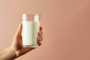 Hand holding a glass of fresh milk with copy space. ai generated photo