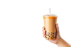 A hand holding takeaway plastic cup of delicious iced bubble milk tea and black pearls isolated on white background with copy space. ai generated photo