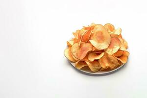 Crispy fried potato chips on a plate isolated on a white background with copy space. ai generated photo