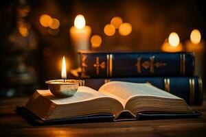An open book with a candle resting on top photo