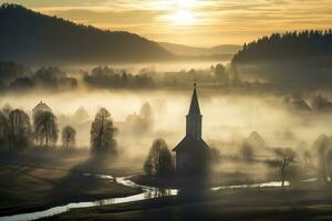 Silhouette of church in misty village landscape viewed from above photo