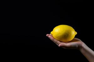 Lemon in hand isolated on black background with copy space. ai generated photo