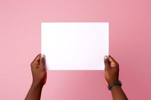 A human hand holding a blank sheet of white paper or card isolated on pink background. ai generated photo