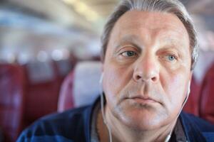 Man listening to music in the airplane photo