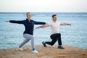 Young couple working out outdoor with music photo