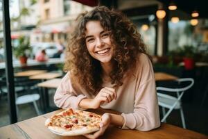 Girl eats pizza in street cafe photo