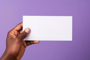 A human hand holding a blank sheet of white paper or card isolated on purple background. ai generated photo