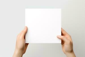 A human hand holding a blank sheet of white paper or card isolated on white background. ai generated photo