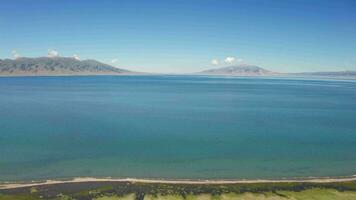 Blue lake and grassland in a sunny day. video