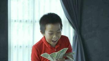 Surprised boy holding money, slow motion shot video