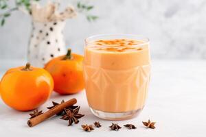 Persimmon, orange and ginger drink with yogurt, photo