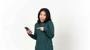 Holding Smartphone with Shocked Face and Pointing Smartphone Of Beautiful Asian Woman Isolated On White Background photo